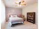 Bedroom showcasing a large window, ceiling fan, decor, comfortable chair, and a charming bookshelf at 8828 Powder Works Dr, Huntersville, NC 28078