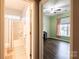 View into full bathroom and bedroom with wood-look floors, ceiling fan, and natural light at 8828 Powder Works Dr, Huntersville, NC 28078