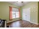 Bedroom showcasing wood-look floors, window, and closet at 8828 Powder Works Dr, Huntersville, NC 28078