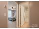 Inviting view through doorways to a bedroom with a ceiling fan and a bright bathroom with a shower-tub combo at 8828 Powder Works Dr, Huntersville, NC 28078