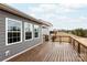 Wooden deck featuring grey siding, white window trim, and black metal railings at 8828 Powder Works Dr, Huntersville, NC 28078