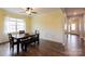 Bright dining room features wood floors, large window, and wainscoting at 8828 Powder Works Dr, Huntersville, NC 28078