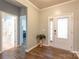 Welcoming foyer with wood floors, white trim, and natural light shining through the front door at 8828 Powder Works Dr, Huntersville, NC 28078