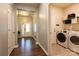 Bright foyer with wood-look flooring leading to laundry room with modern washer and dryer at 8828 Powder Works Dr, Huntersville, NC 28078