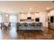 Modern kitchen boasts white cabinets, quartz countertops, stainless appliances, and a large island at 8828 Powder Works Dr, Huntersville, NC 28078