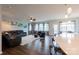Open-concept living room with hardwood floors, comfortable seating, and natural light from windows at 8828 Powder Works Dr, Huntersville, NC 28078