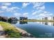 Expansive lake reflecting blue sky and upscale condominiums, blending natural beauty with sophisticated community living at 9035 J M Keynes Dr # 33, Charlotte, NC 28262