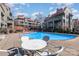 Enjoy the community pool surrounded by condos, seating and landscaping, creating a perfect space for socializing and relaxation at 9035 J M Keynes Dr # 33, Charlotte, NC 28262