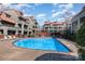 Relaxing community pool surrounded by attractive condominium buildings providing a resort-style living experience at 9035 J M Keynes Dr # 33, Charlotte, NC 28262