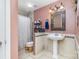 Cozy bathroom features a pedestal sink, decorative mirror, and tile accents at 9035 J M Keynes Dr # 33, Charlotte, NC 28262