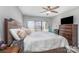 Spacious bedroom featuring a large bed, wood furniture, and a large window for ample natural light at 9035 J M Keynes Dr # 33, Charlotte, NC 28262