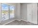 Well-lit bedroom corner featuring a window, closet, neutral walls, and tile flooring, ready for customization at 9035 J M Keynes Dr # 33, Charlotte, NC 28262