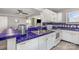 Open concept kitchen with white cabinetry, blue tile countertops, and stainless steel appliances at 9035 J M Keynes Dr # 33, Charlotte, NC 28262