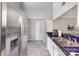 Kitchen with stainless steel refrigerator, tiled floors, and a countertop with blue-tiled trim at 9035 J M Keynes Dr # 33, Charlotte, NC 28262
