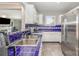 Bright kitchen featuring white cabinetry, blue tiled countertops, and stainless steel appliances at 9035 J M Keynes Dr # 33, Charlotte, NC 28262
