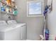 Functional laundry room with modern washer and dryer, shelving, and natural light at 9035 J M Keynes Dr # 33, Charlotte, NC 28262