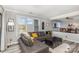 Cozy living room showcasing a gray leather sectional, wood flooring, and an open view to the dining area at 9035 J M Keynes Dr # 33, Charlotte, NC 28262