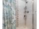 Modern shower with tiled walls, rainfall showerhead, built-in shelving, and decorative curtain at 9035 J M Keynes Dr # 33, Charlotte, NC 28262