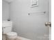 Bathroom area featuring a standard toilet, towel bar and neutral paint at 9035 J M Keynes Dr # 33, Charlotte, NC 28262