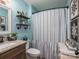 This bathroom features a vanity with storage, mirror and a shower with blue walls at 944 Clear Creek Cir, Lincolnton, NC 28092