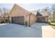 A two-car garage features brick veneer and dark-stained wooden doors for a sophisticated, modern look at 944 Clear Creek Cir, Lincolnton, NC 28092