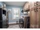 Laundry room boasts lots of natural light and built-in shelving perfect for organizing supplies at 944 Clear Creek Cir, Lincolnton, NC 28092