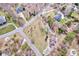High-angle view exhibiting a Gathering-friendly neighborhood, with this home nestled on a large lot with mature trees at 105 Partridge Bluff Ne Dr, Concord, NC 28025