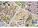 Birds-eye view displaying a peaceful residential area, with this home on a spacious lot amidst tree-lined streets at 105 Partridge Bluff Ne Dr, Concord, NC 28025