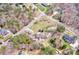 Overhead view reveals this home nestled among verdant trees in a tranquil neighborhood on an oversized lot at 105 Partridge Bluff Ne Dr, Concord, NC 28025