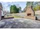 Backyard with stone fireplace and sitting area perfect for entertaining guests at 105 Partridge Bluff Ne Dr, Concord, NC 28025