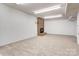 Finished basement with neutral carpet and a cozy brick fireplace at 105 Partridge Bluff Ne Dr, Concord, NC 28025