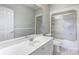 Clean bathroom with white vanity, bathtub, shower and frosted glass enclosure at 105 Partridge Bluff Ne Dr, Concord, NC 28025