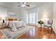 Bright bedroom featuring hardwood floors, a bay window, and a ceiling fan, creating a comfortable retreat at 105 Partridge Bluff Ne Dr, Concord, NC 28025