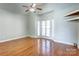 Sun-filled bedroom with wood floors, built-in shelving, and a bay window with views at 105 Partridge Bluff Ne Dr, Concord, NC 28025