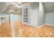 Bright bonus room featuring unique built-in shelving and a ceiling fan, providing ample space for various activities at 105 Partridge Bluff Ne Dr, Concord, NC 28025