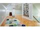 Versatile bonus room with built-in shelving, natural light, and hardwood floors, perfect for recreation at 105 Partridge Bluff Ne Dr, Concord, NC 28025