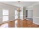 Elegant dining room with hardwood floors, chandelier, crown molding and natural light from large windows at 105 Partridge Bluff Ne Dr, Concord, NC 28025