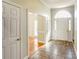 Inviting foyer with tiled floor, white door with glass sidelights and view to the light-filled living room at 105 Partridge Bluff Ne Dr, Concord, NC 28025