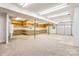 Spacious garage with storage shelving along the back wall, offering ample room for parking and projects at 105 Partridge Bluff Ne Dr, Concord, NC 28025