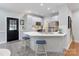 Stylish kitchen featuring stainless steel appliances, white cabinets, and bar seating at 105 Partridge Bluff Ne Dr, Concord, NC 28025