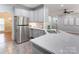 Modern kitchen with stainless steel appliances, white cabinets, and ample counter space at 105 Partridge Bluff Ne Dr, Concord, NC 28025