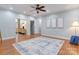 Spacious living room with hardwood floors, neutral walls, ceiling fan, and ample natural light at 105 Partridge Bluff Ne Dr, Concord, NC 28025