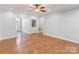 Spacious living room with hardwood floors and neutral paint, and doorway to the foyer at 105 Partridge Bluff Ne Dr, Concord, NC 28025