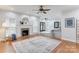 Open-concept living room with a fireplace and view to kitchen and outdoor area at 105 Partridge Bluff Ne Dr, Concord, NC 28025