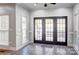Cozy sunroom with tile flooring and plenty of natural light from the surrounding windows and glass pane doors at 105 Partridge Bluff Ne Dr, Concord, NC 28025