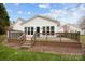 Large wooden back porch with black metal railing and stairs leading into the spacious backyard at 121 Yorkshire Dr, Salisbury, NC 28144