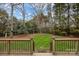 Grassy backyard featuring a wooden porch with black metal railing and a swing set at 121 Yorkshire Dr, Salisbury, NC 28144