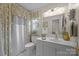 Bright bathroom with white vanity, decorative mirror, patterned curtain and natural lighting at 121 Yorkshire Dr, Salisbury, NC 28144