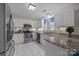 Bright kitchen with white cabinets, granite countertops, stainless steel appliances, and tile flooring at 121 Yorkshire Dr, Salisbury, NC 28144