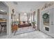 Bright, airy living room with tile floors, a comfortable leather sofa, and multiple windows at 121 Yorkshire Dr, Salisbury, NC 28144
